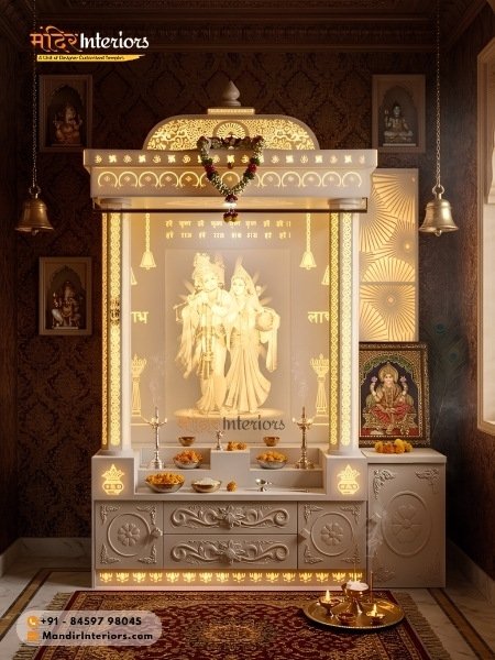 Corian pooja room design radha krishna backlit statue ornate arch hanging bells